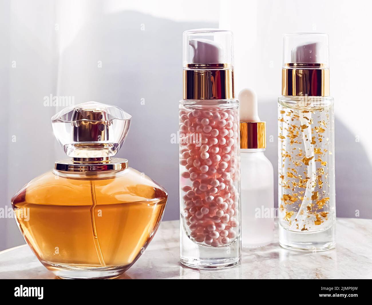 Skincare and make-up cosmetics, golden serum emulsion bottles and perfume, beauty product Stock Photo