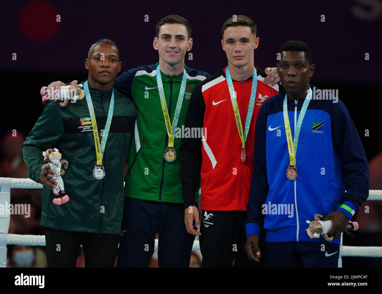 Northern Ireland's AIdan Walsh with his Gold Medal (centre left), Mozambique's Tiago Osorio Muxanga with his Silver Medal (left) and Wales’ Taylor Bevan with his Bronze Medal after the Men's Light Middle (67-71kg) Final at The NEC on day ten of the 2022 Commonwealth Games in Birmingham. Picture date: Sunday August 7, 2022. Stock Photo