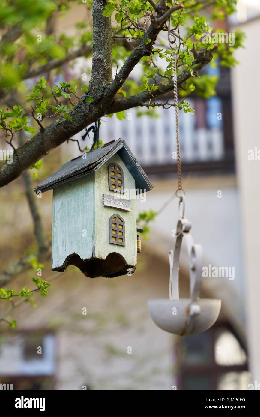 Wooden bird house as decoration in a tree in the garden Stock Photo