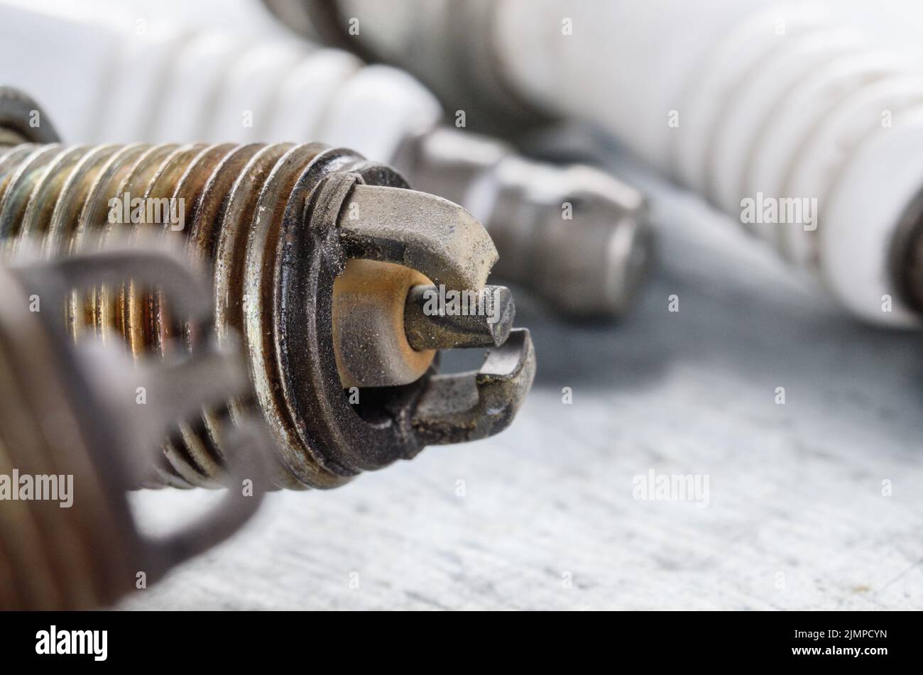 Closeup photo of old used spark plug for internal combustion engine. Space for text Stock Photo