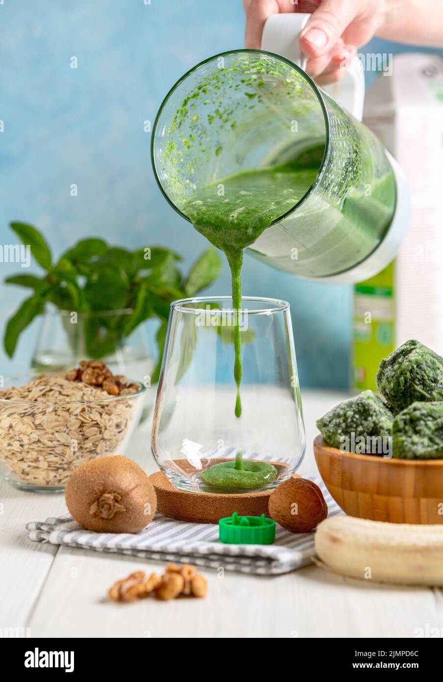 Smoothie made from frozen spinach, banana, kiwi and almond milk Stock