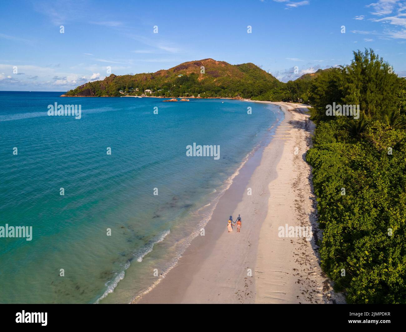 Drone aerial view of the beach of Praslin Seychelles Anse Volbert, couple men and women walking at the beach Stock Photo