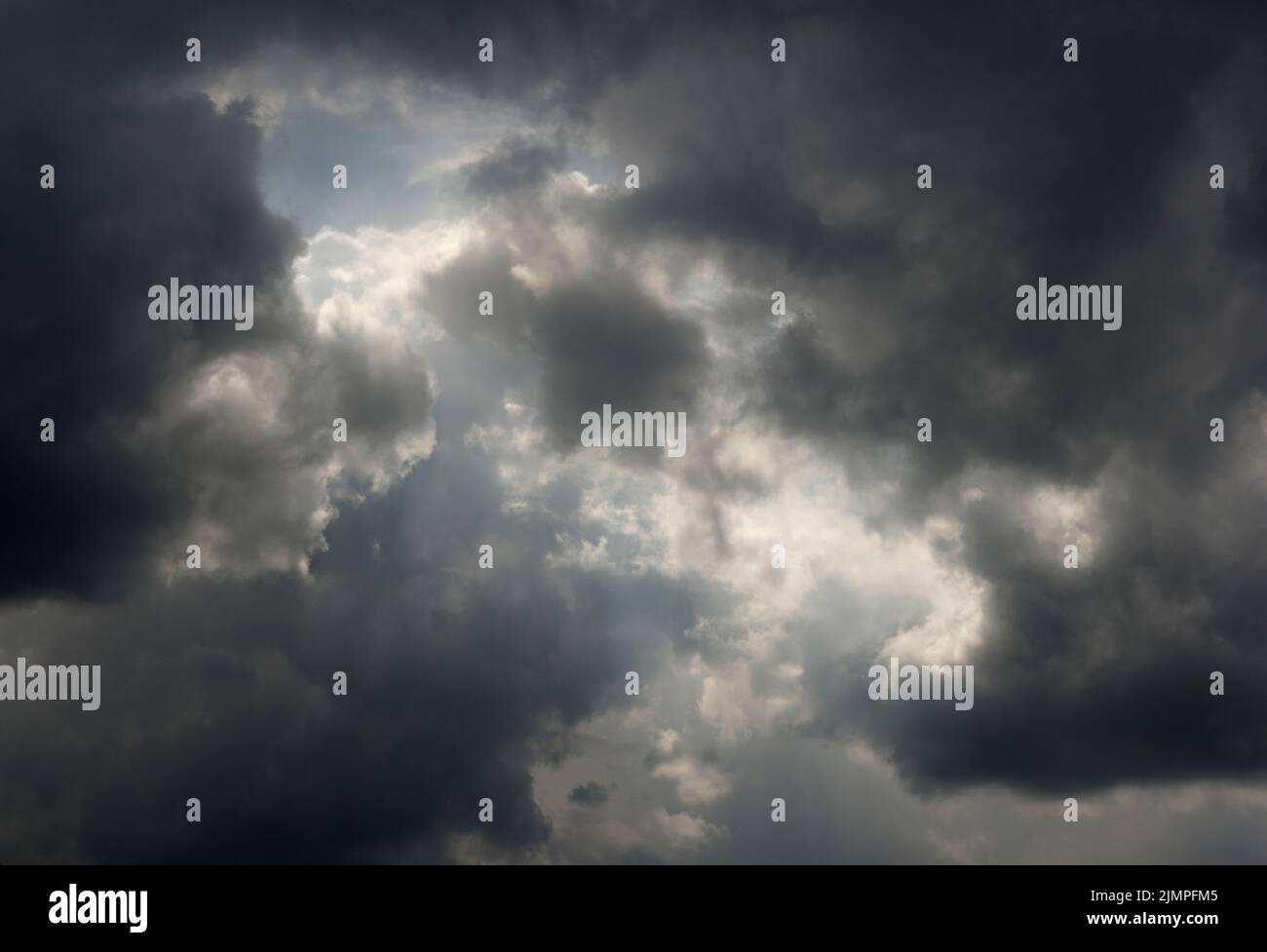 Dark clouds gathering with a slight clearing Stock Photo