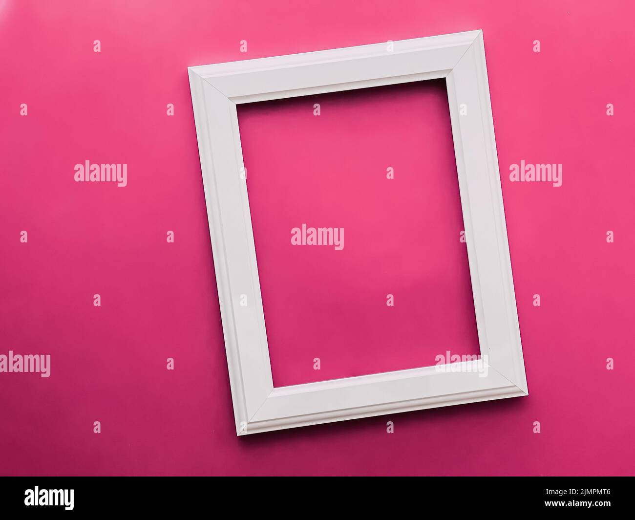 White vertical art frame on pink background as flatlay design, artwork print or photo album Stock Photo