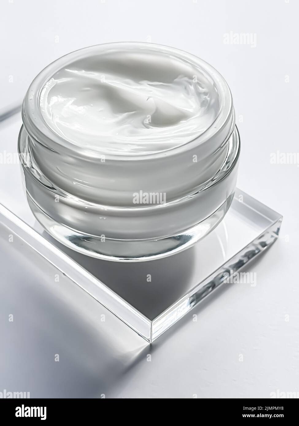 Face cream moisturiser jar and product sample on glass, beauty and