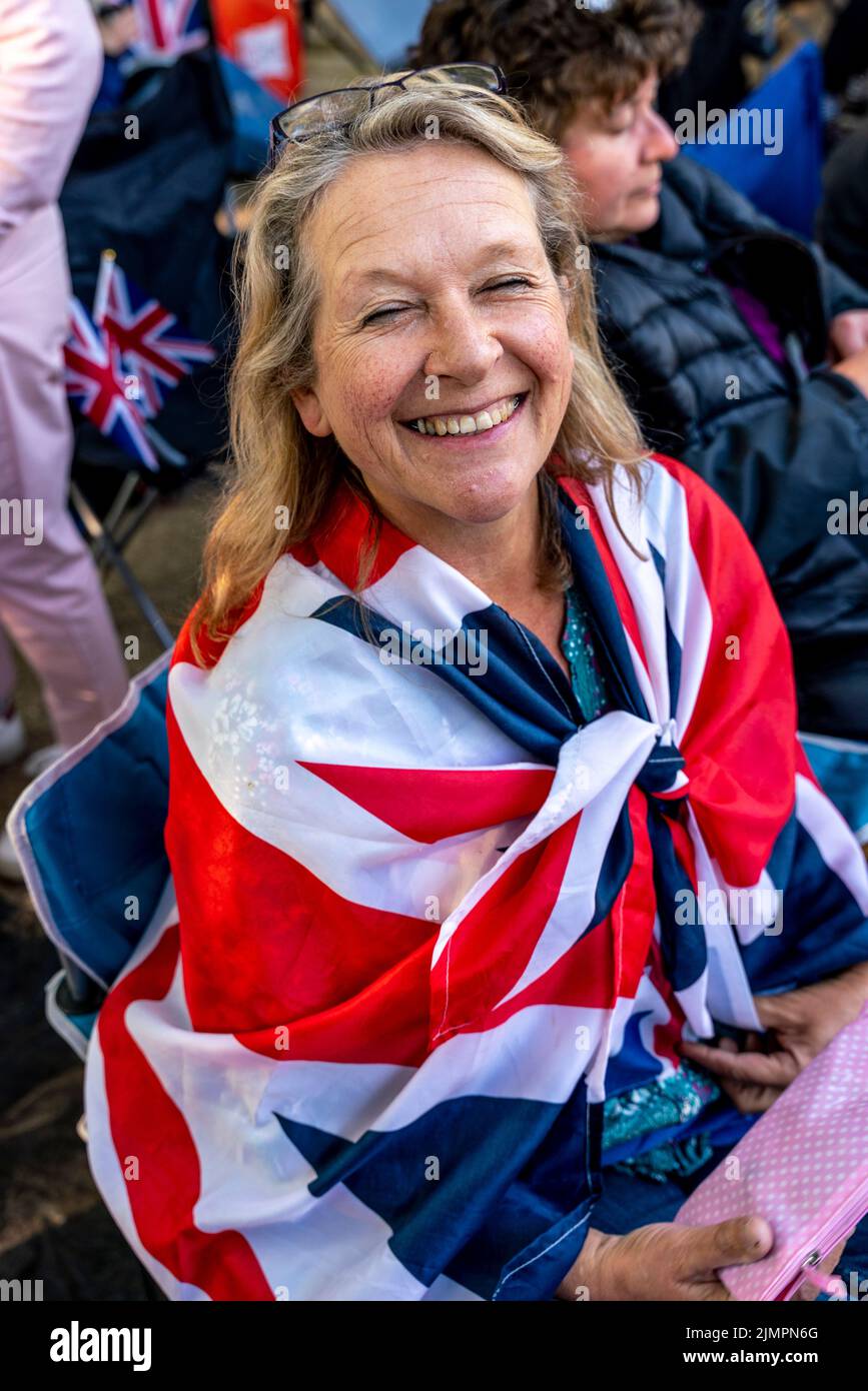 A Middle Aged British Woman Having Camped Out Overnight Along The Mall Waits for The Queen's Birthday Parade To Begin, The Mall, London, UK. Stock Photo