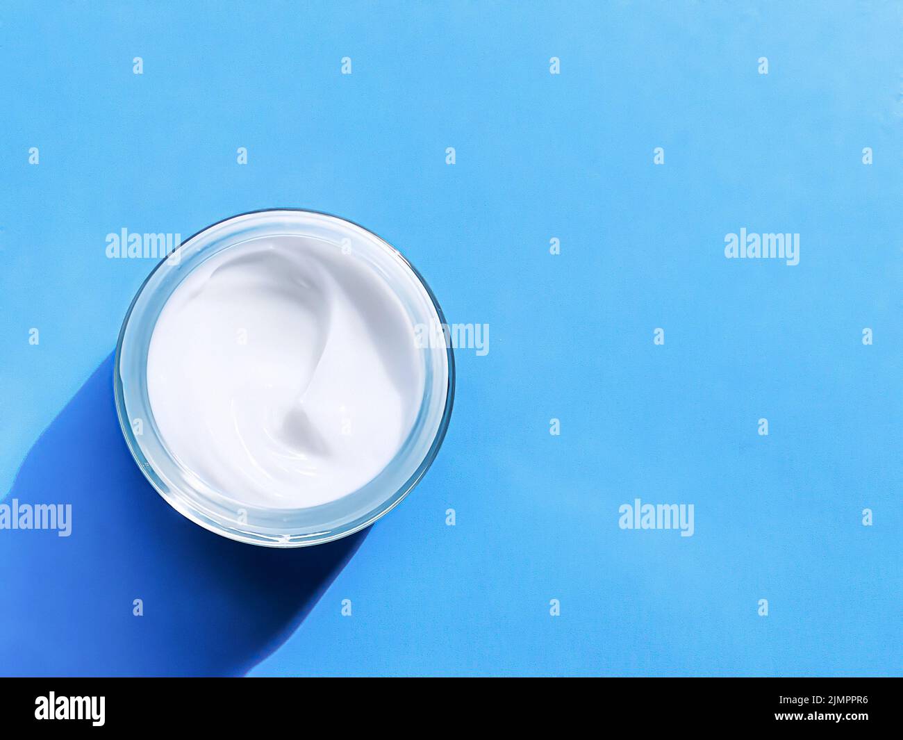 Face cream moisturiser jar as product sample on blue background, beauty and skincare, cosmetic science Stock Photo