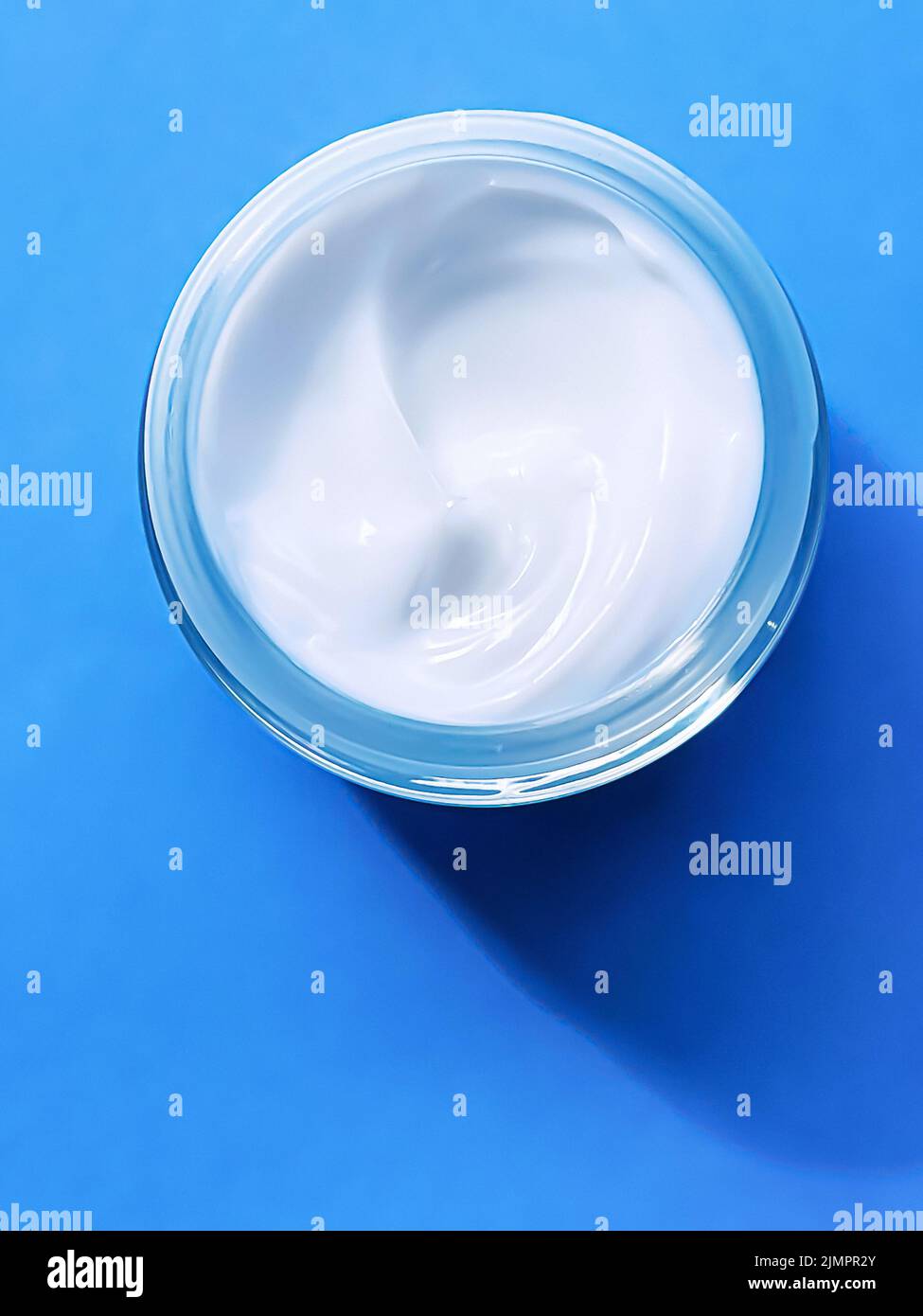 Face cream moisturiser jar as product sample on blue background, beauty and skincare, cosmetic science Stock Photo