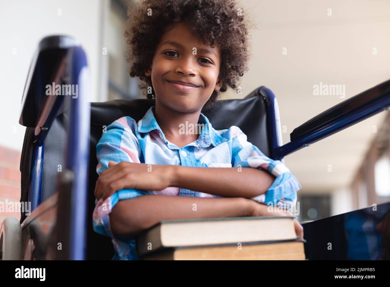 Low angle portrait of smiling african american elementary schoolboy ...