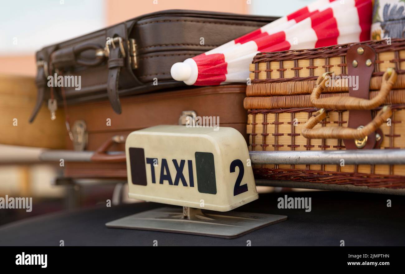 Close-up of the luggage rack of a taxi with several suitcases. Retro style, 70's and 80's. Concept of tourism and travelling on holidays. Stock Photo