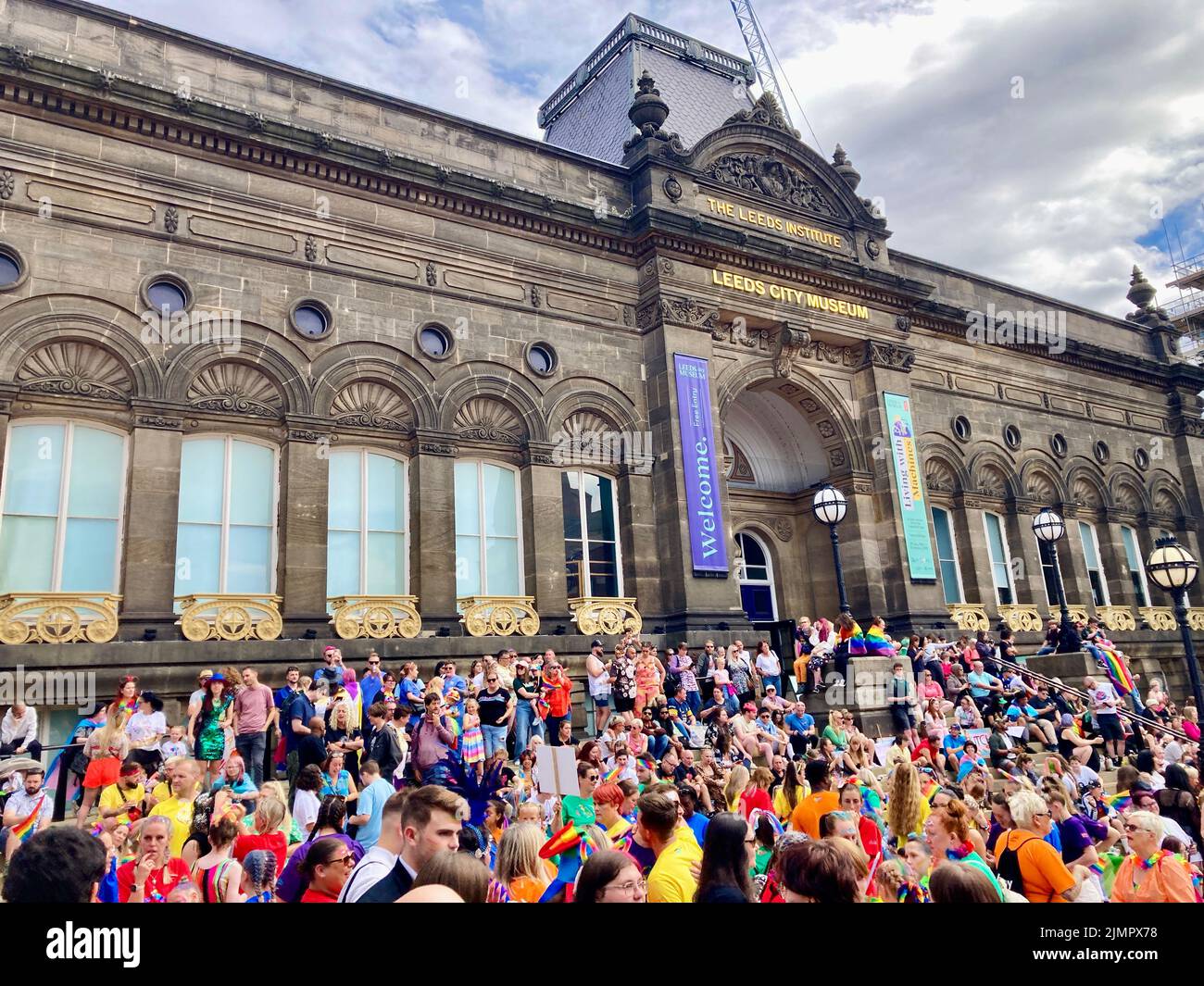 Leeds Pride 2022 celebrations as a crowd gather at Millenium Square for the beginniLeng of the parade. Celebrating gay people & wider LGBTQ community. Stock Photo