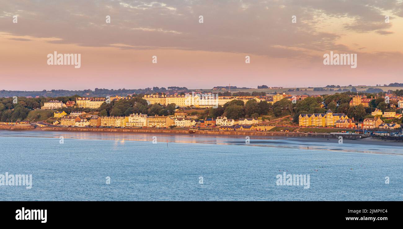 Early morning view of the seaside town of Filey from Filey Brigg on the Yorkshire coast in England, taken just after sunrise. Stock Photo