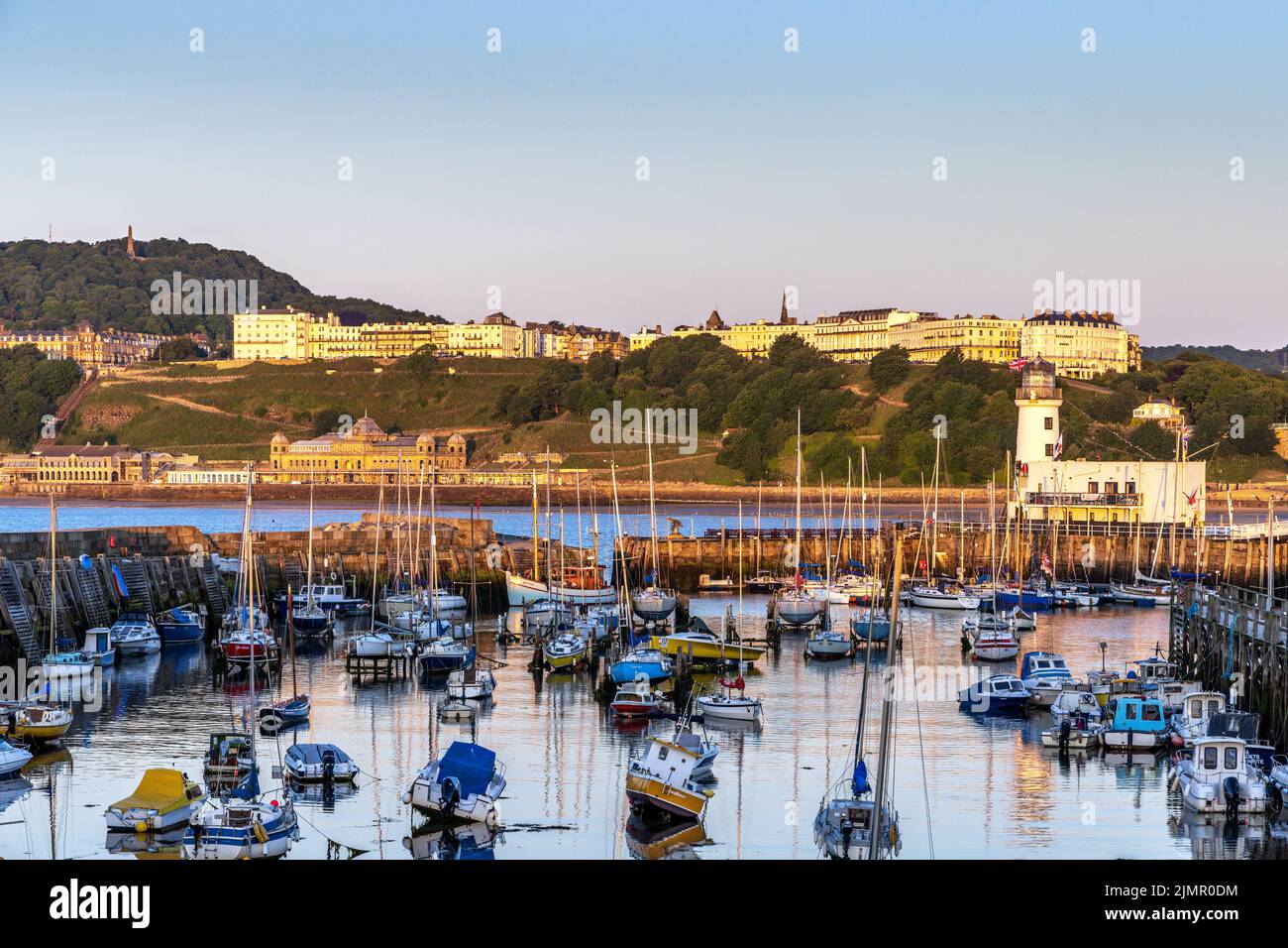 Early morning sun lights up Scarborough Harbour and the seaside town of Scarborough in North Yorkshire. Stock Photo
