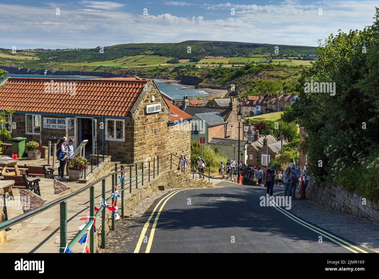 The steep hill leading down to the seafront and beach in the old fishing and smuggling village of Robin Hood's Bay in North Yorkshire, England. Stock Photo