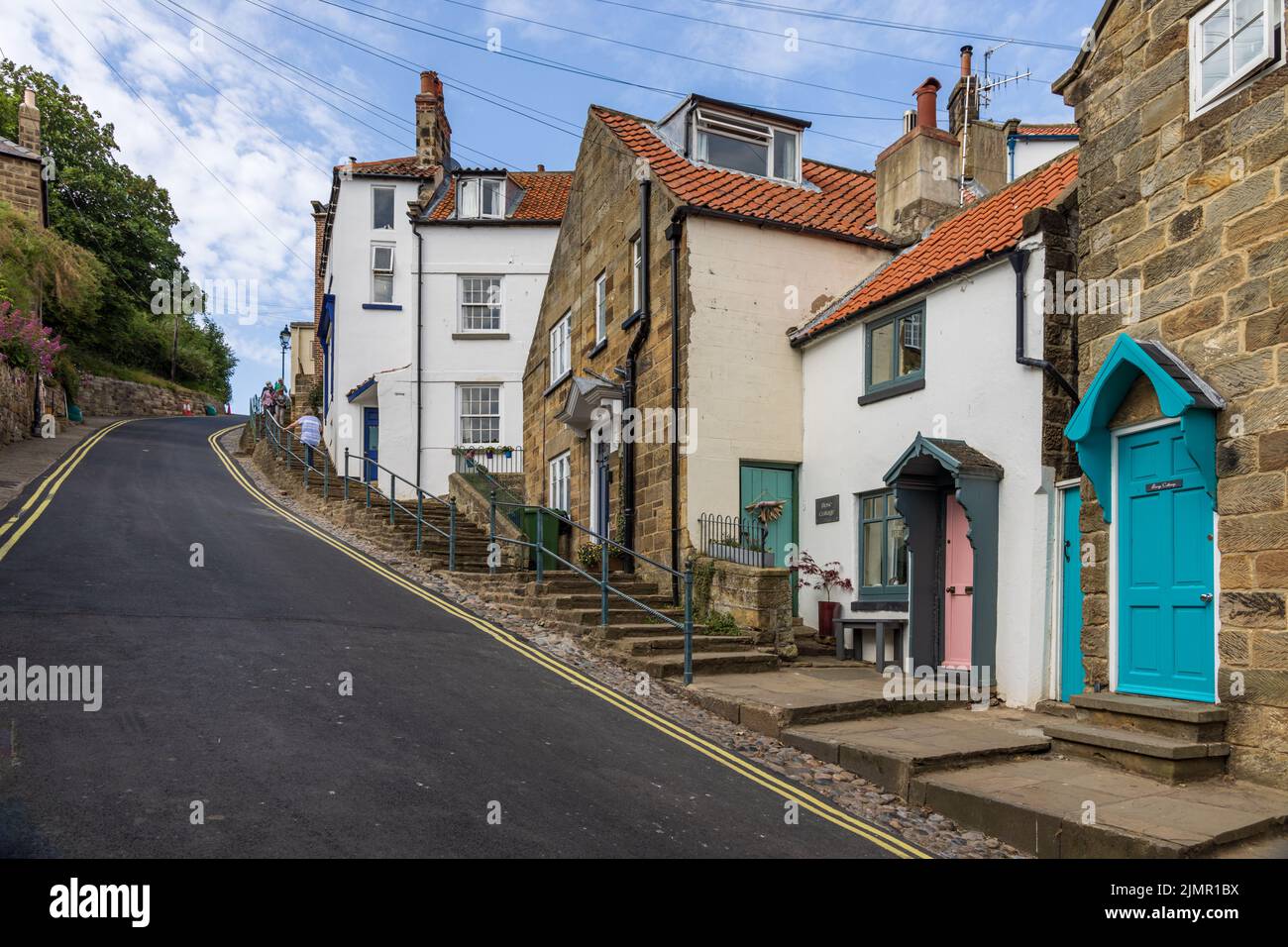 The steep hill from the seafront and beach in the old fishing and smuggling village of Robin Hood's Bay in North Yorkshire, England Stock Photo