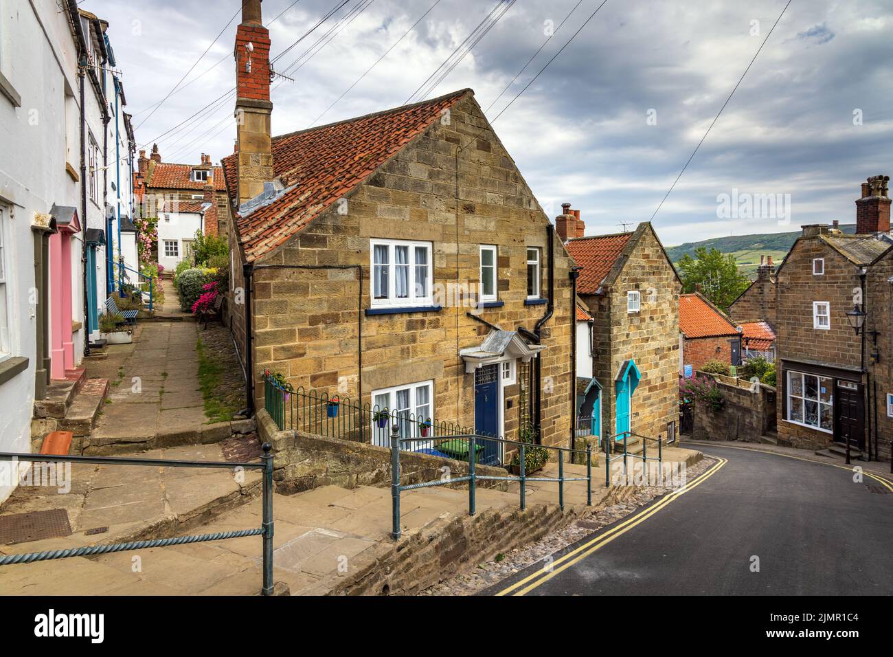 The steep hill leading down to the seafront and beach in the old fishing and smuggling village of Robin Hood's Bay in North Yorkshire, England. Stock Photo
