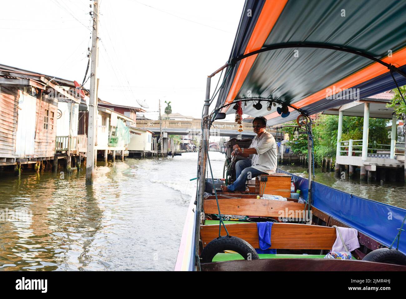 Chao Phraya River Canal Cruise boat and captain. Traditional canal tour boats. Stock Photo