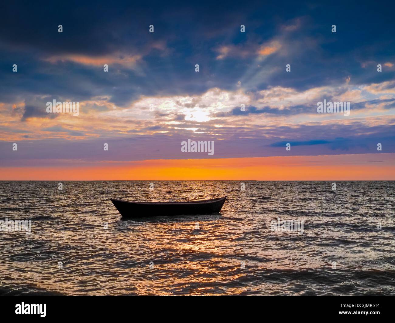 Silhouette of an empty boat in the sea at sunset background Stock Photo ...