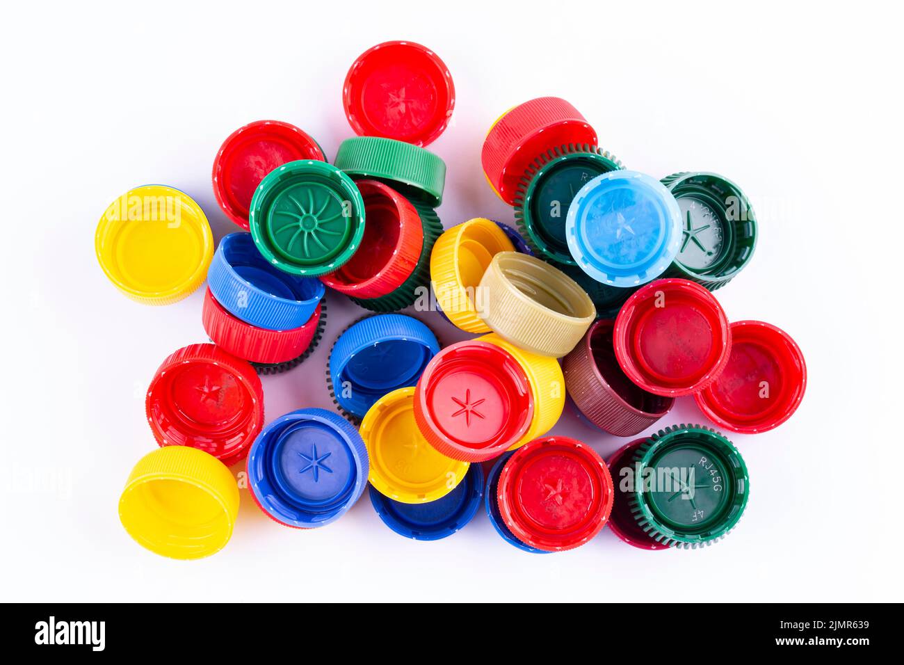 Plastic bottle caps on white background. Cap material is recyclable