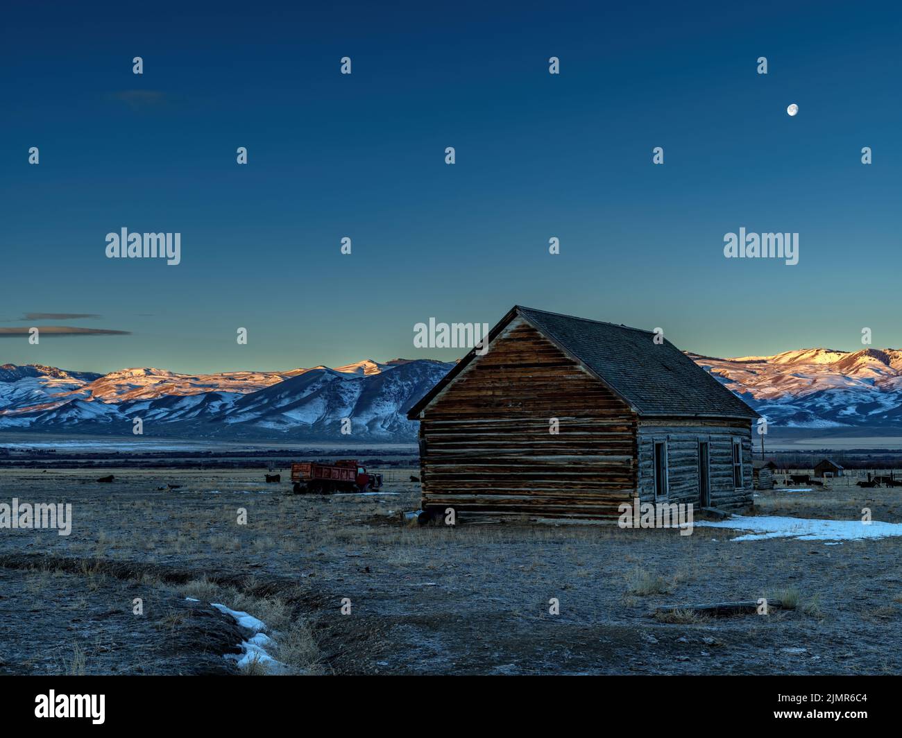 Log shed on an Idaho ranch morning with moon Stock Photo