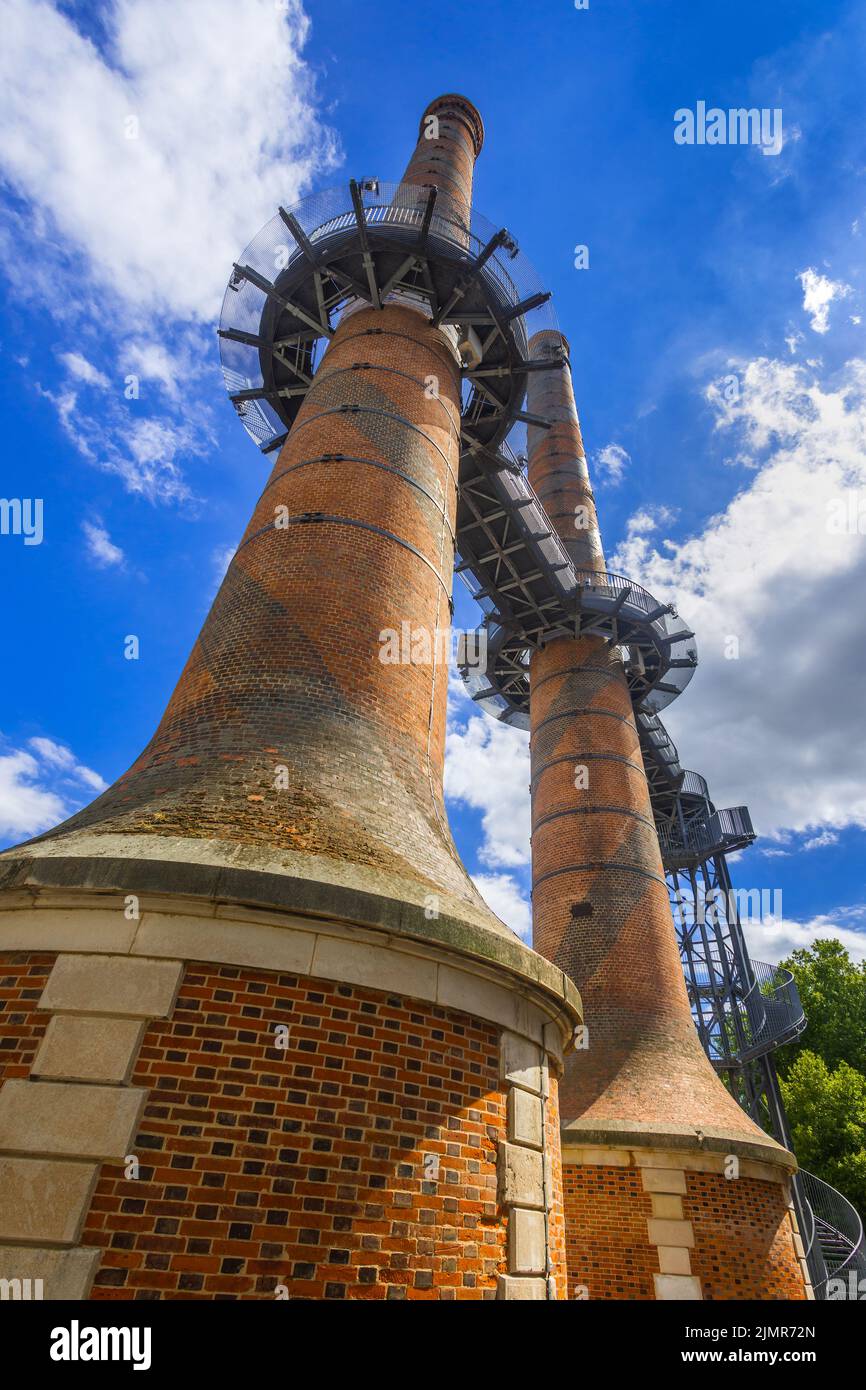 Famous chimneys of the 19th century Le Manu arms factory, with an 18 meter high metal spiral staircase and walkway, Chatellerault, Vienne (86), France. Stock Photo