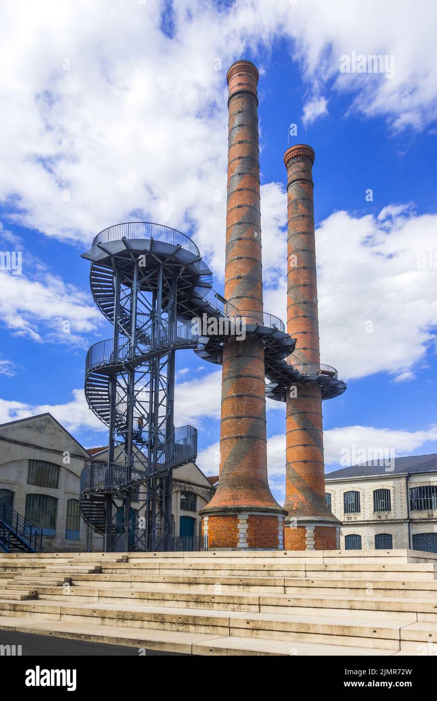 Famous chimneys of the 19th century Le Manu arms factory, with an 18 meter high metal spiral staircase and walkway, Chatellerault, Vienne (86), France. Stock Photo