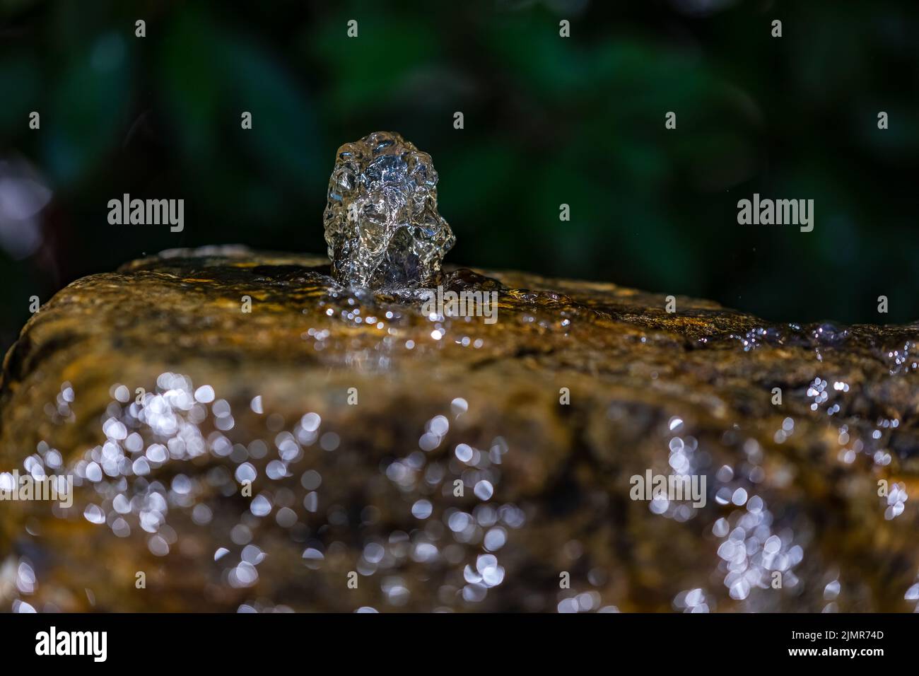 Water from a well released in continuous movement Stock Photo