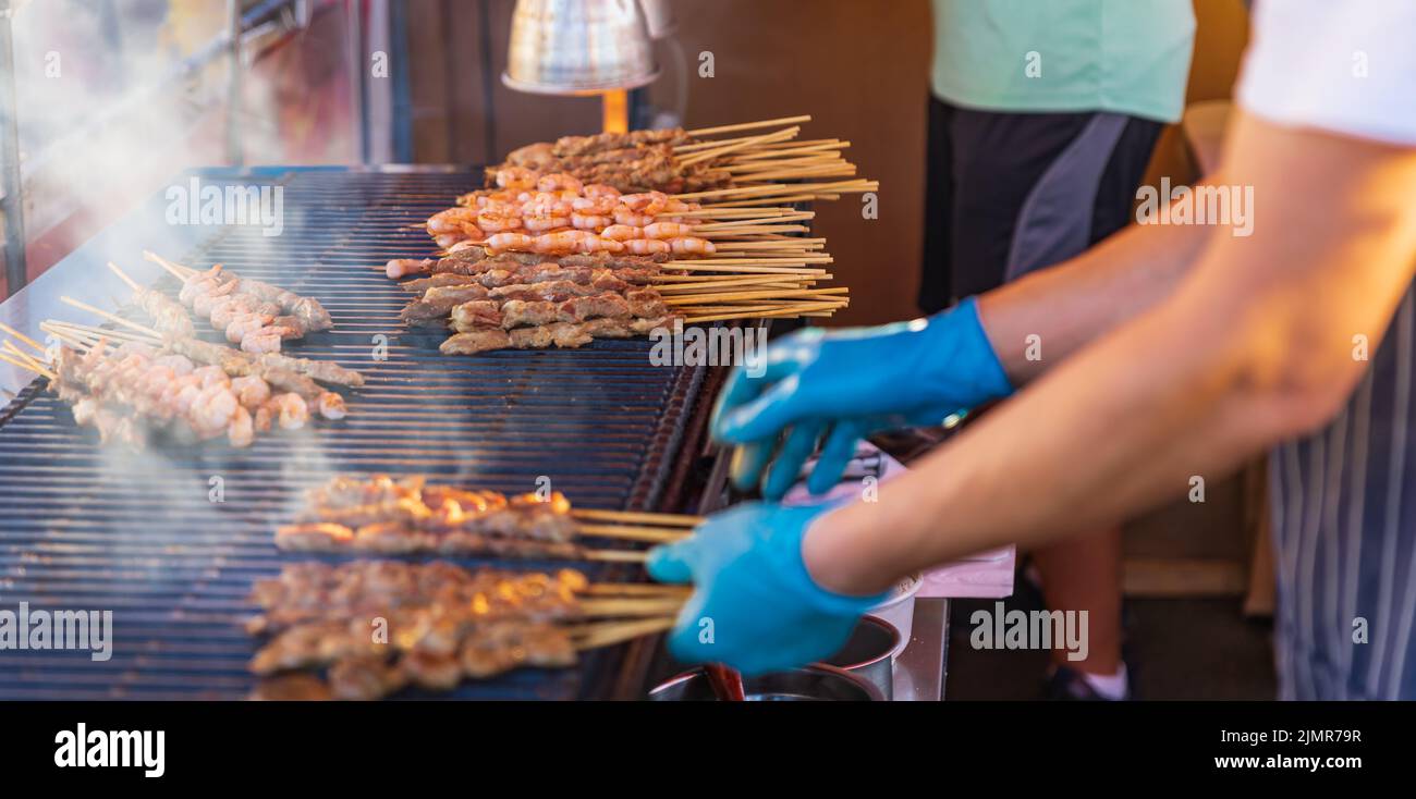 Premium Photo  Closeup of grilled skewered milk pork on stick thai street  food market