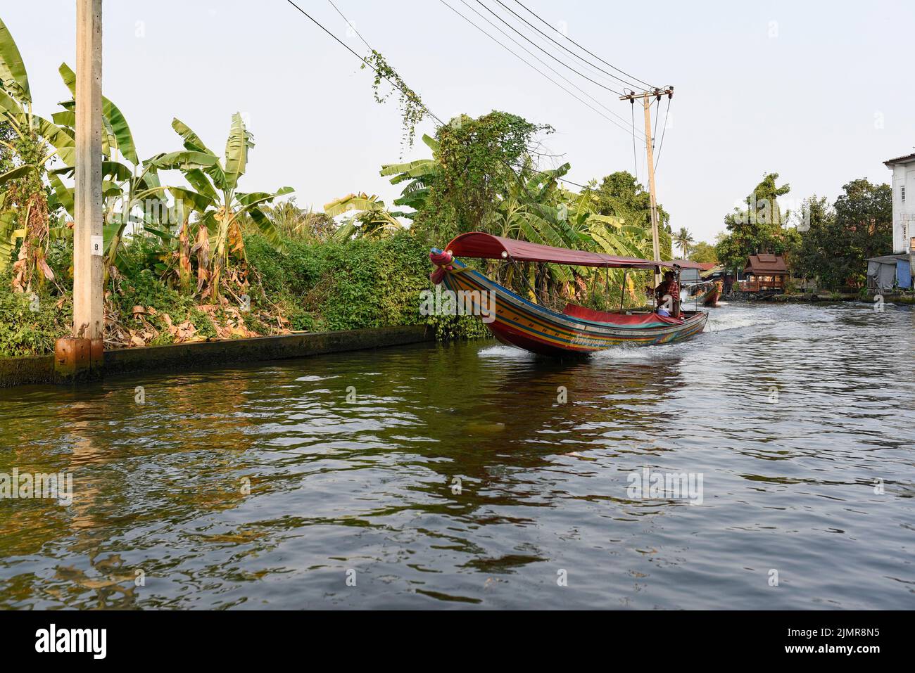 Chao Phraya River Canal Cruise boats and tourists. Traditional canal houses and life. Stock Photo