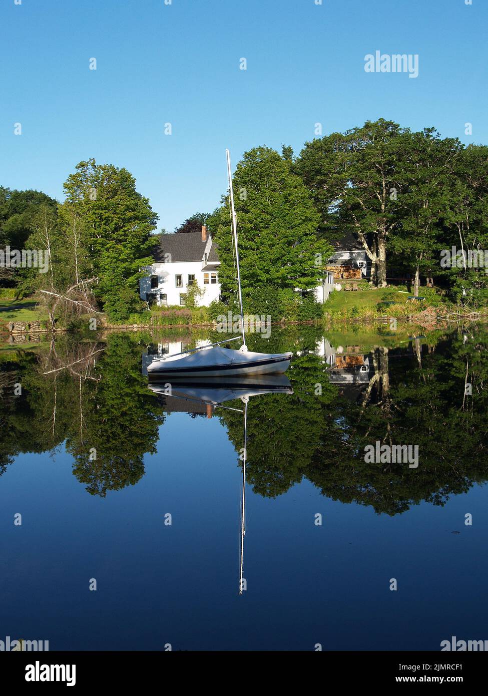 Lake reflection with boat,Harrisville,New Hampshire Stock Photo