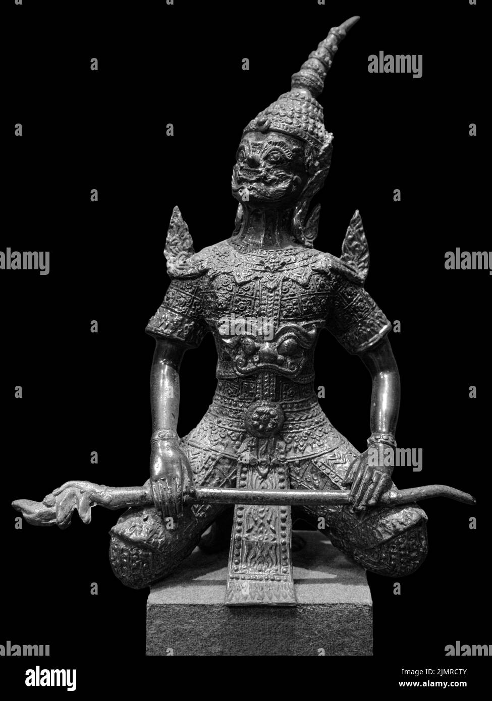 Bronze hanuman statue isolated over black. Hanuman sits in lotus pose with mace Stock Photo