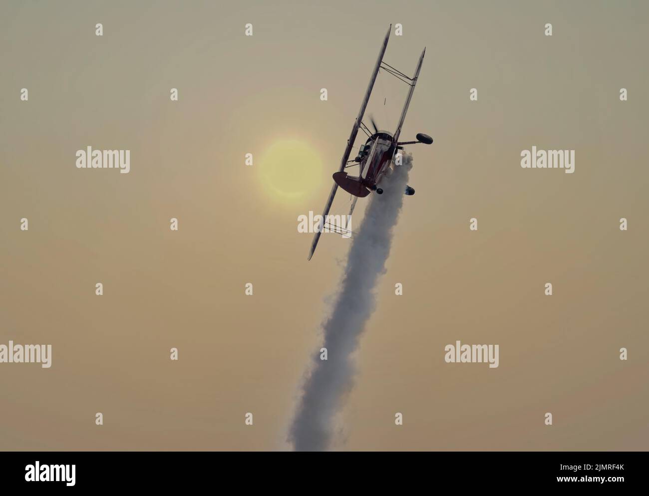 Vicky Benzing's Boeing Stearman PT17 climbs into the sun over Boundary Bay Canada Stock Photo