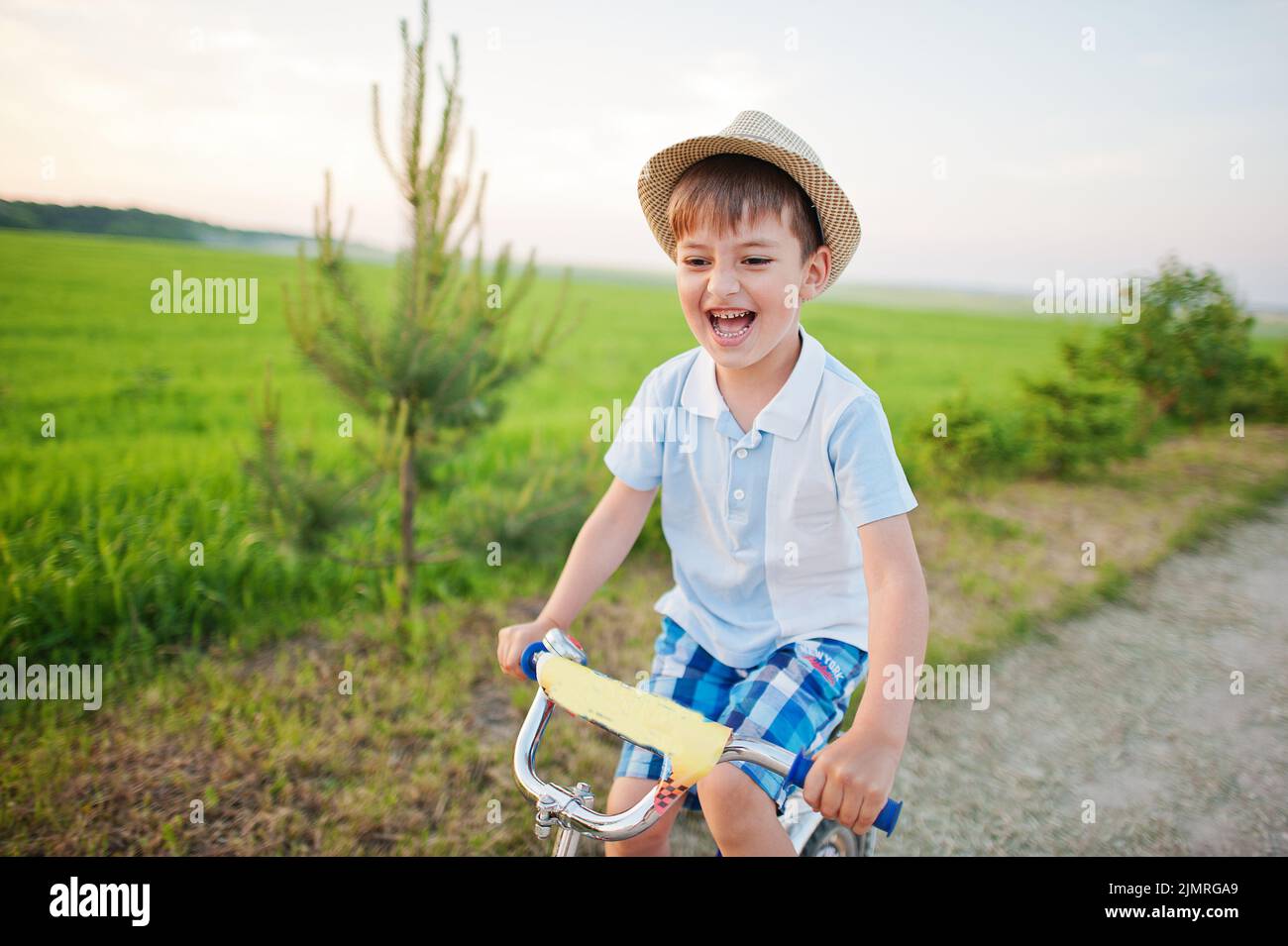 Boy wear hat in bicycle, happy children moments Stock Photo Alamy