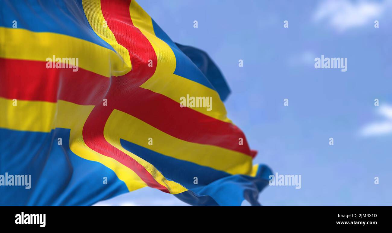 The flag of Aland Island waving in the wind on a clear day Stock Photo ...