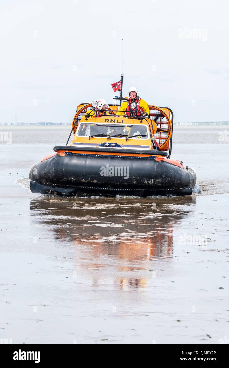 RNLI hovercraft in Southend on Sea, Essex, UK, far out on the mud at low tide. Used by Southend RNLI due to large expanse of intertidal zone low tide Stock Photo