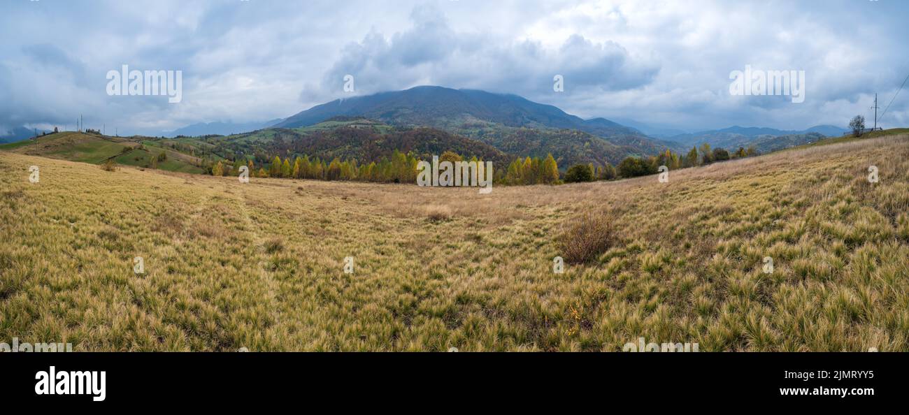 Cloudy and foggy day autumn mountains scene. Peaceful picturesque traveling, seasonal, nature and countryside beauty concept sce Stock Photo