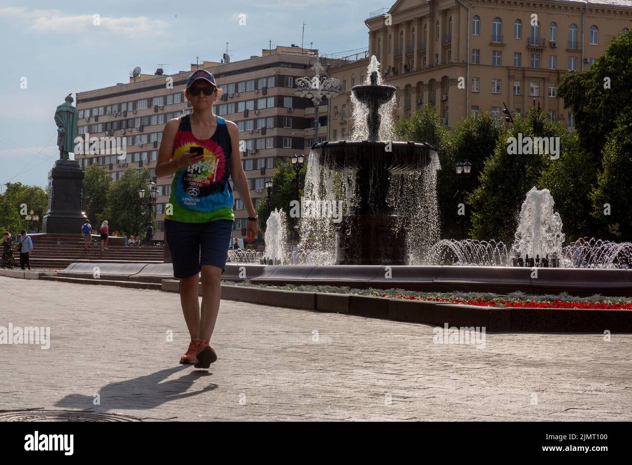Moscow, Russia. 7th of August, 2022. People walk around Pushkin Square by the fountain on a sultry hot day Stock Photo