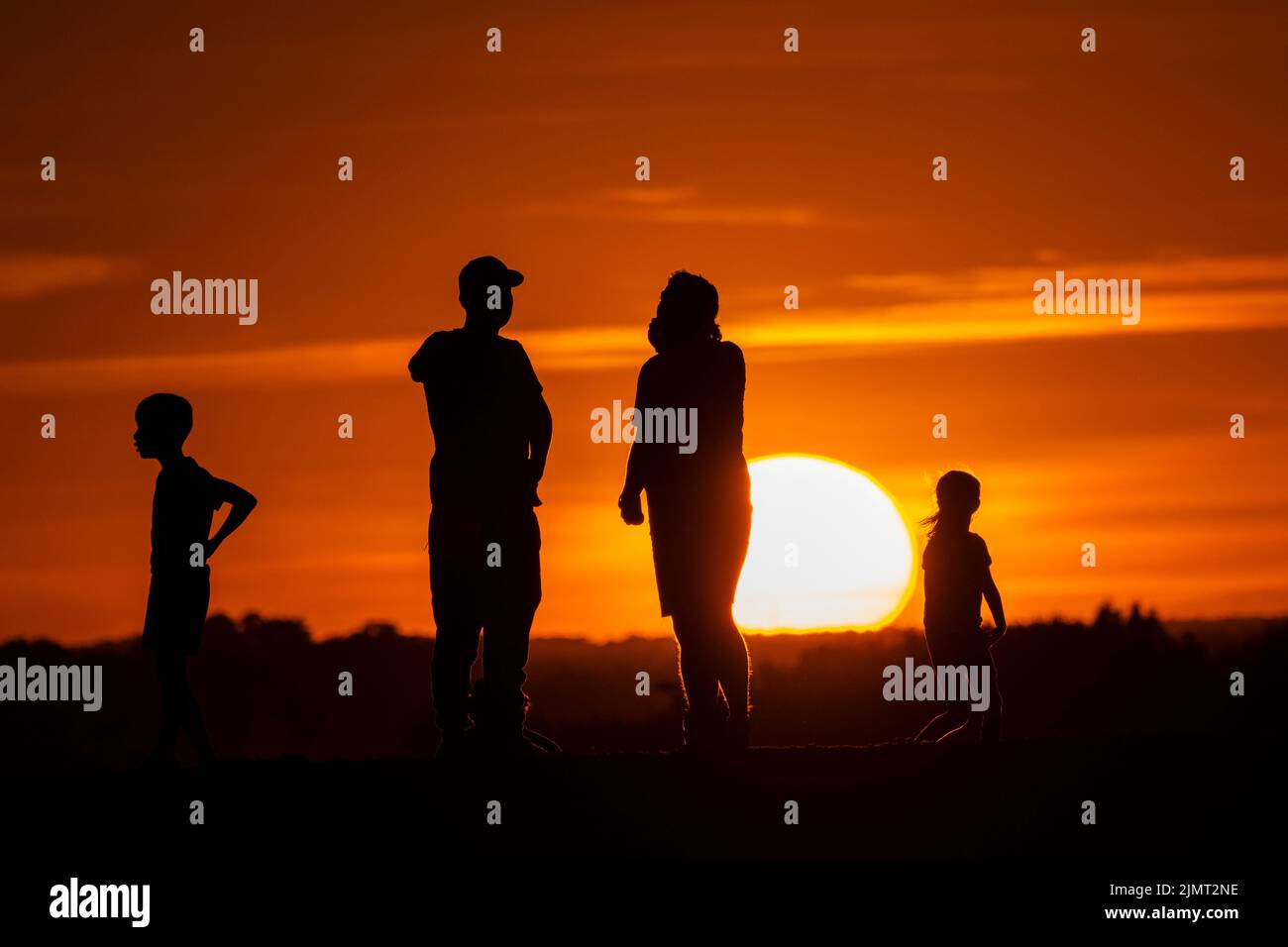 London, UK.  7 August 2022.  UK Weather – People view the sunset at Northala Fields near Northolt in west London.  According to the Met Office, July 2022 was the driest July for England since 1935.  Hose pipe bans are in place in certain areas as drought conditions continue, with temperatures exceeding 30C in the south expected next week. Credit: Stephen Chung / Alamy Live News Stock Photo