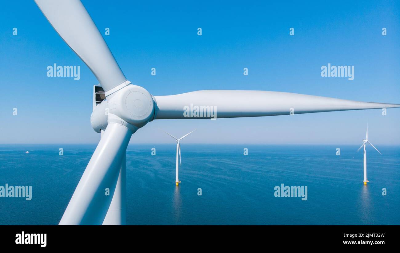 Windmill park in the ocean, drone aerial view of windmill turbines generating green energy electric, windmills isolated at sea i Stock Photo