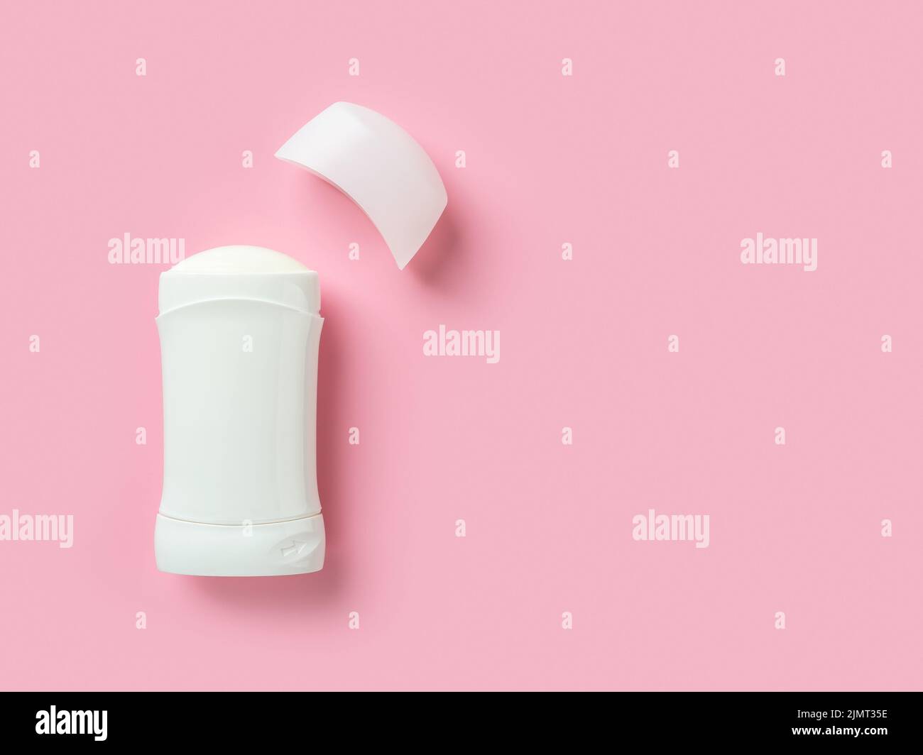 Solid antiperspirant over pink background with copy space. Open white