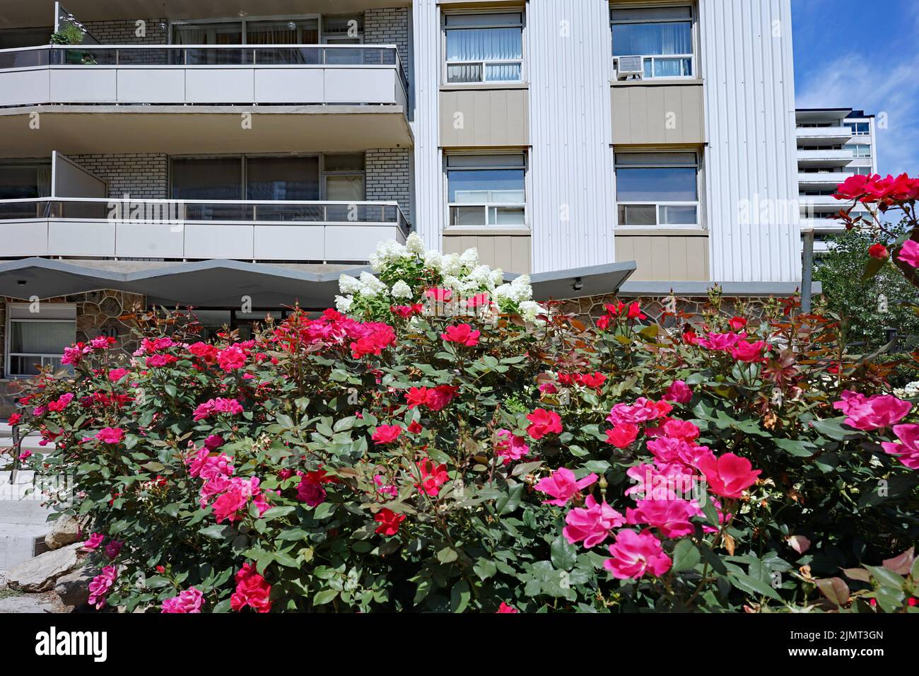 Front of apartment building decorated with colorful flowers Stock Photo