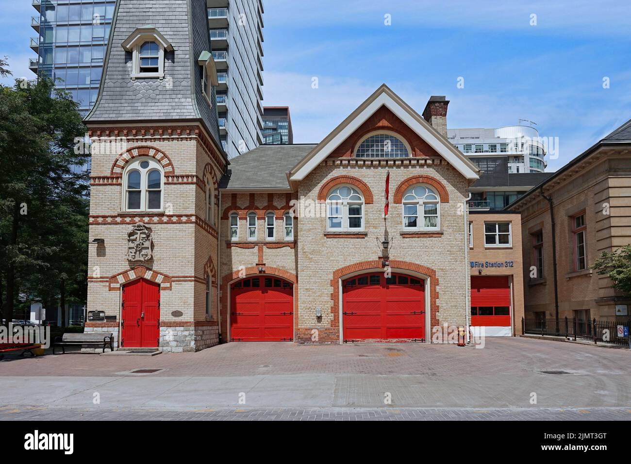 Old fashioned fire station surrounded by modern apartment buildings Stock Photo