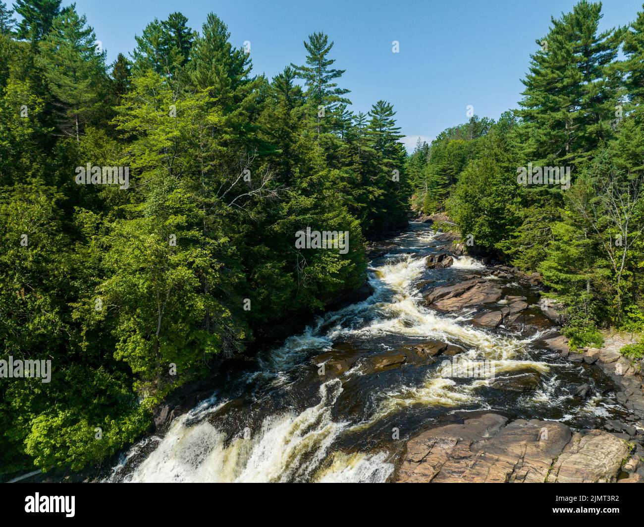 Beautiful waterfall flowing during summer in a northern forest in Canada Stock Photo