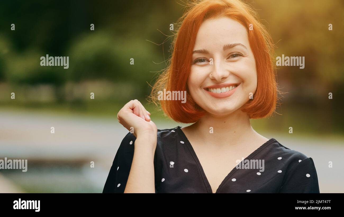 Caucasian thoughtful creative woman redhead young girl student thinking choose ponder planning holds hand to chin makes finger up excited with good Stock Photo