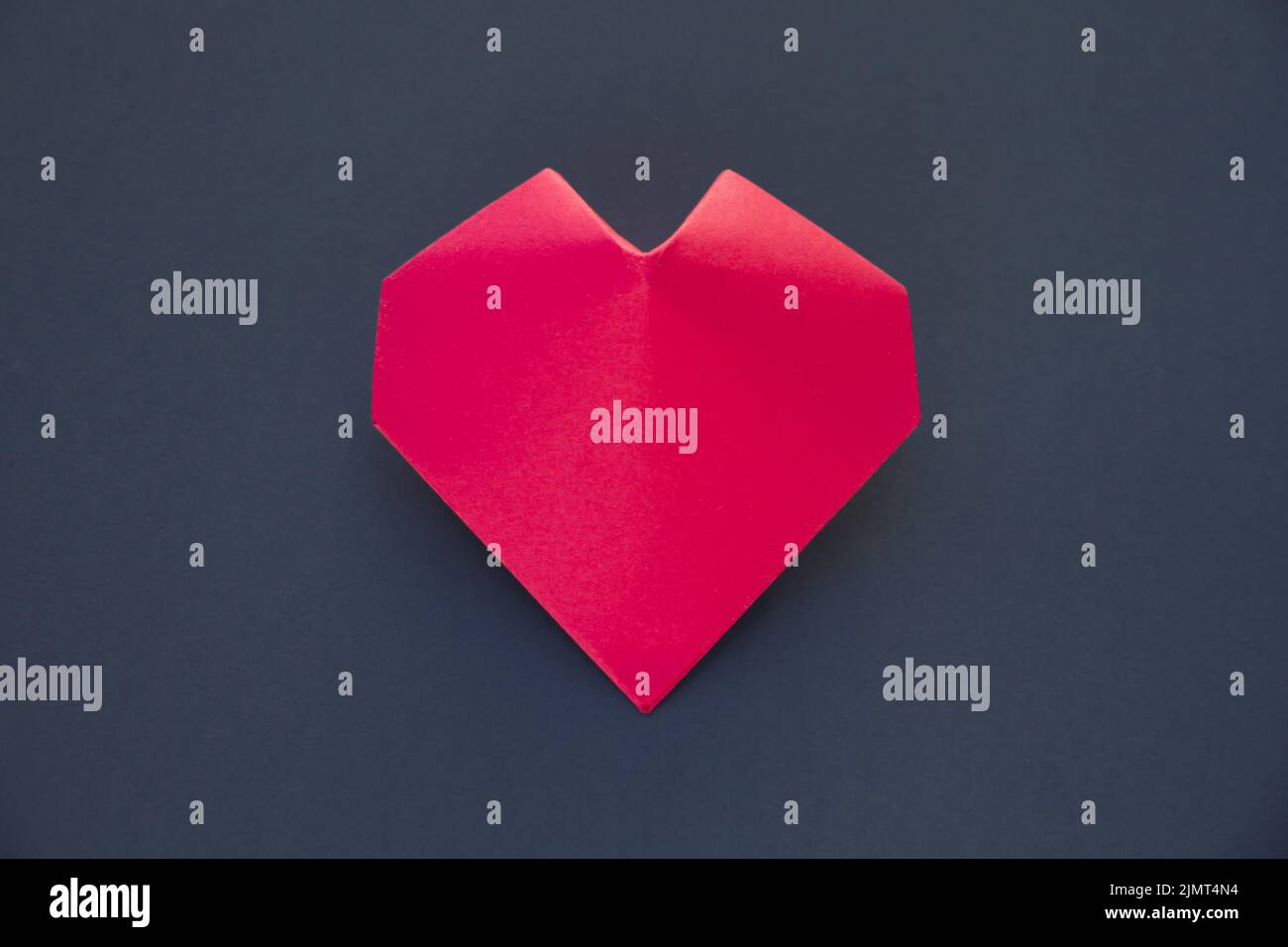 Red paper heart origami isolated on a grey background Stock Photo