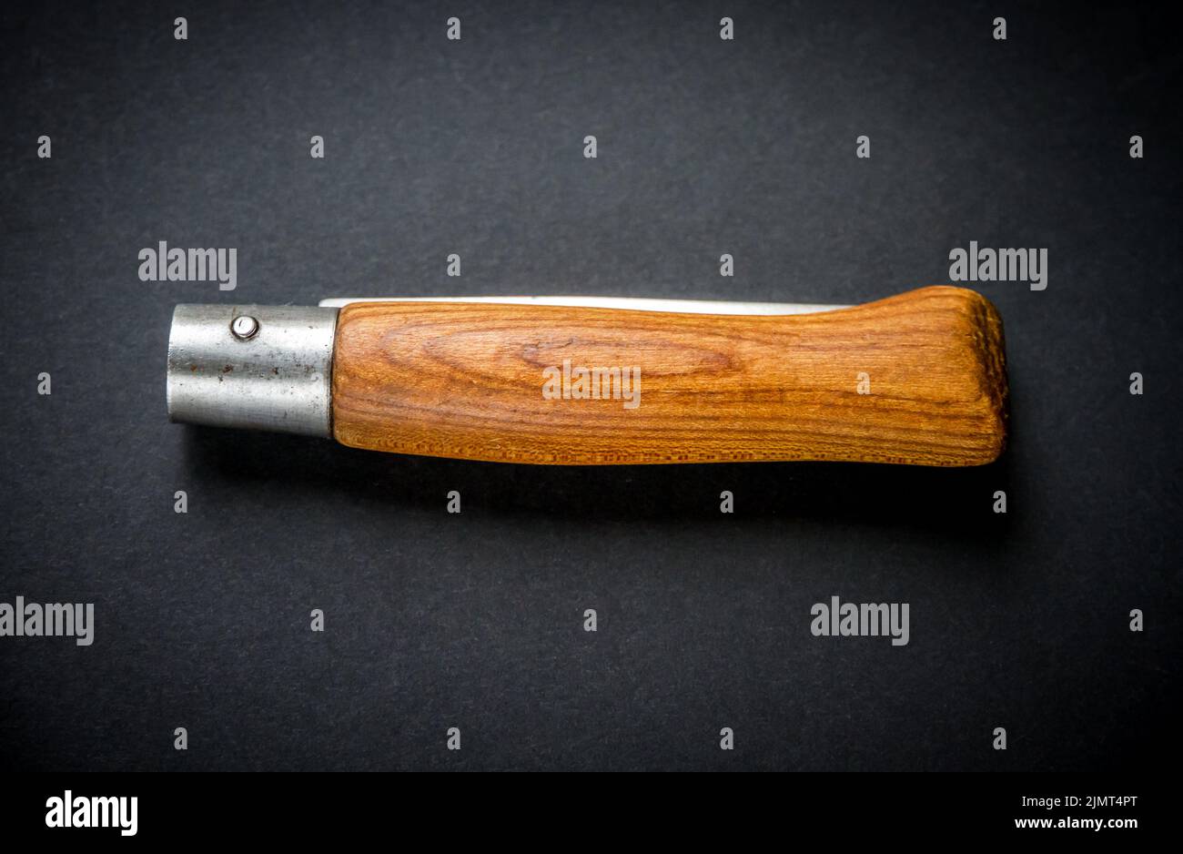 Traditional wooden pocket knife on black background Stock Photo