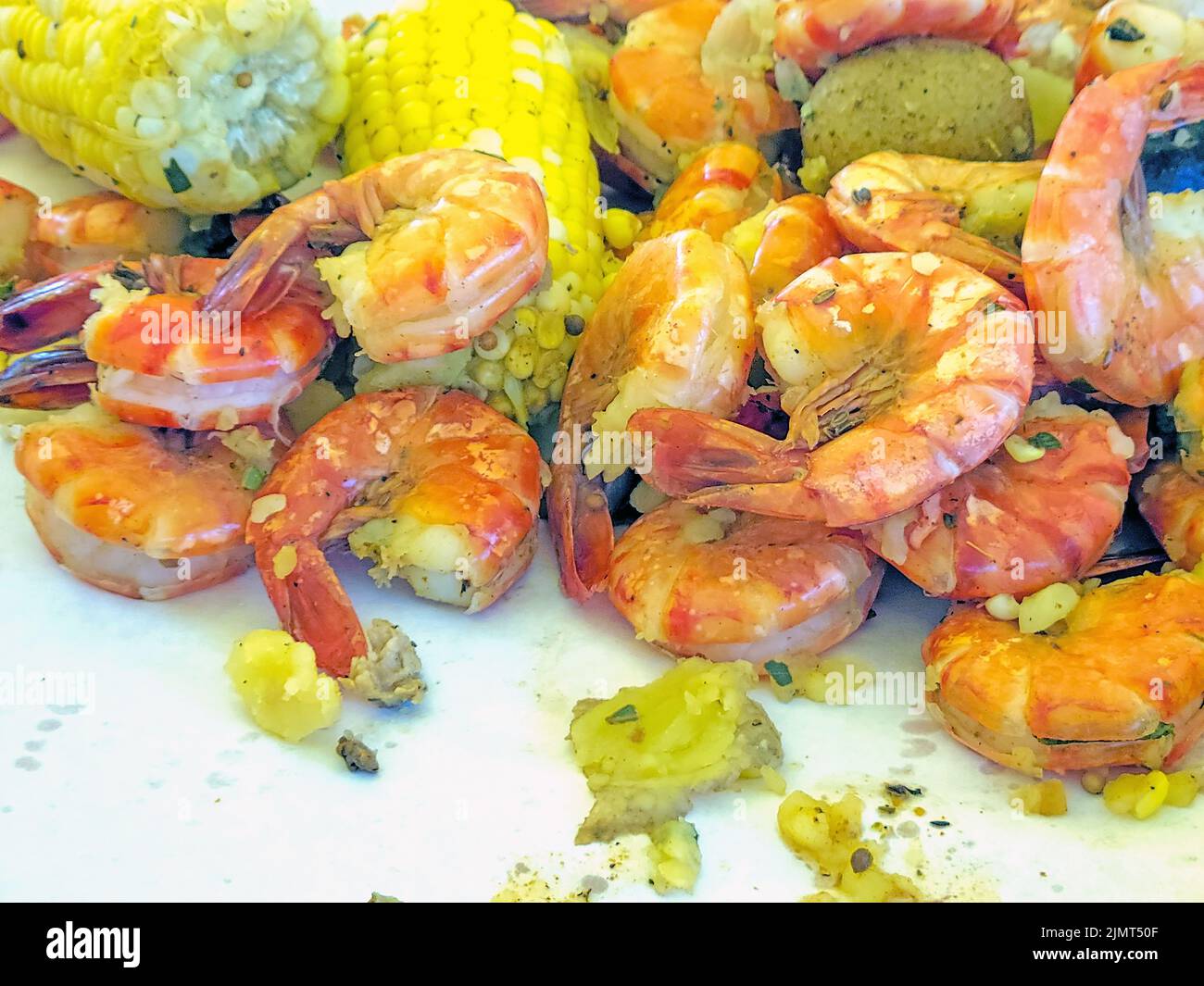Close up of cooked shrimp, corn on the cob, and potatoes Stock Photo