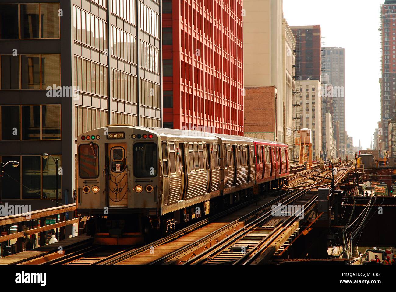 An elevated train, or L train, heads into a station between the ...