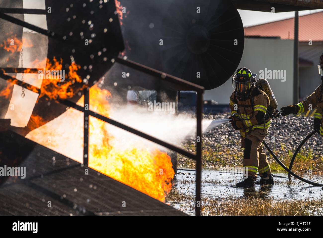 U.S. Air Force Airman Daniel Griffin, 6th Civil Engineer Squadron firefighter, puts out a fire on an inflamed test aircraft during an aircraft rescue and firefighting proficiency training at MacDill Air Force Base, Florida, Aug. 5, 2022. ARFF training helps prepare Air Force firefighters to manage compromised aircraft in emergency situations. (U.S. Air Force photo by Airman 1st Class Joshua Hastings) Stock Photo