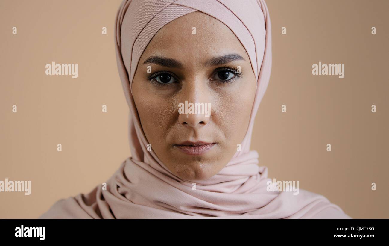 Portrait of upset muslim girl woman in hijab headscarf islamic young anxious lonely lady in desperate looking at camera indoors worry about religious Stock Photo